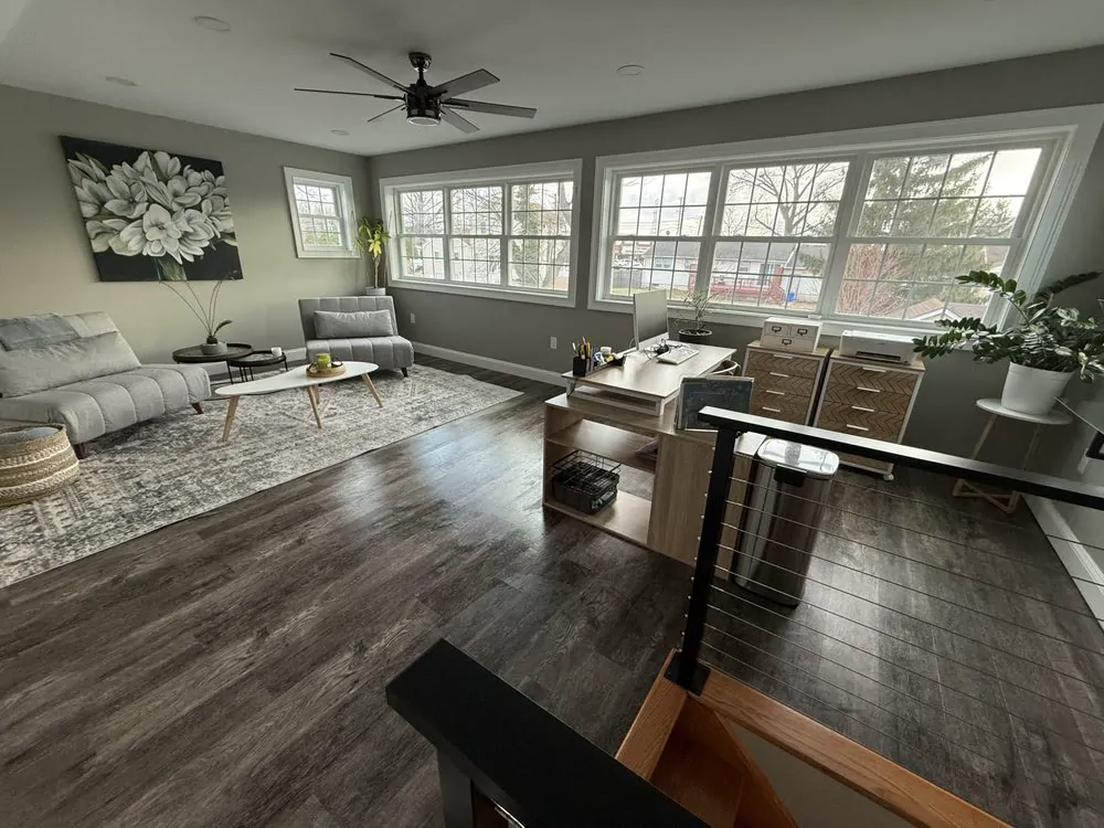 A living room with a grey sofa and a patterned rug after a Pura Clean visit